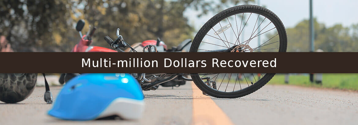 Multi-million Dollars Recovered! bike and helmet on road after bike accident to represent bicycle accident case