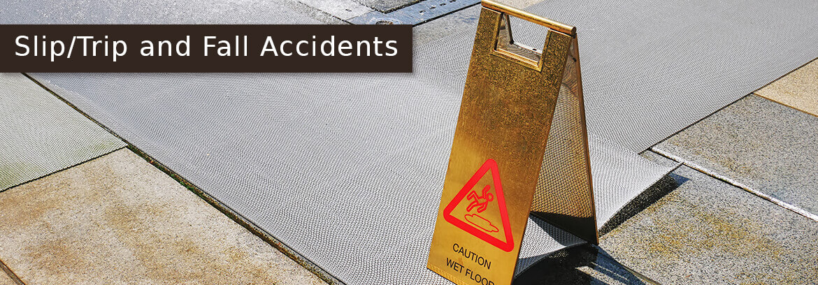 Work Place Accidents Personal Injury Cases - Law Offices of Brian Larsen ground under construction with caution floor sign with caption Slip/Trip and Fall Accidents