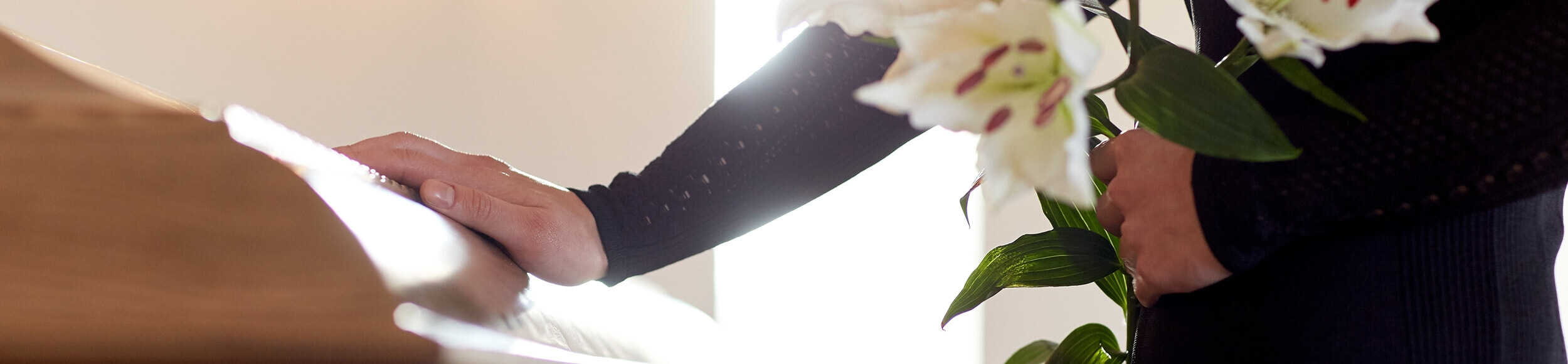 Wrongful Death woman hand on casket to represent wrongful death cases we win