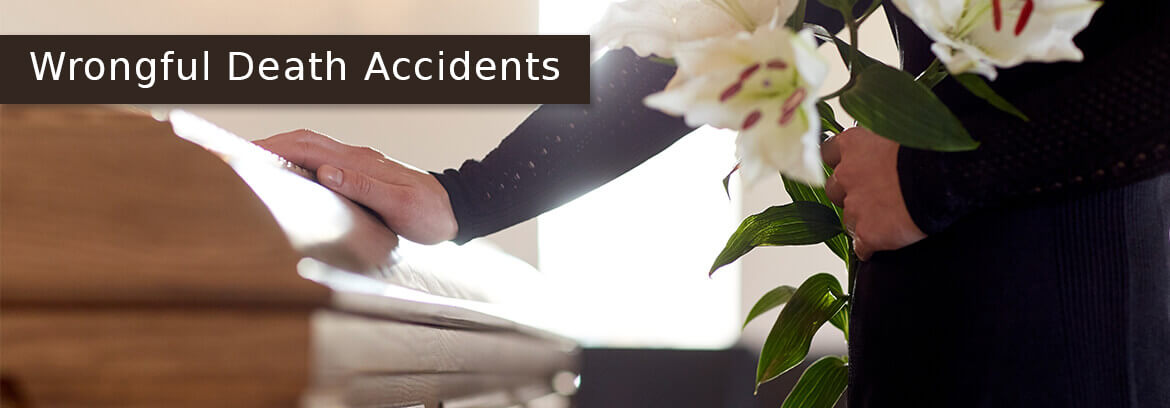 Wrongful Death Personal Injury Cases - Law Offices of Brian Larsen woman hand on casket holding flowers with caption Wrongful Death Accidents